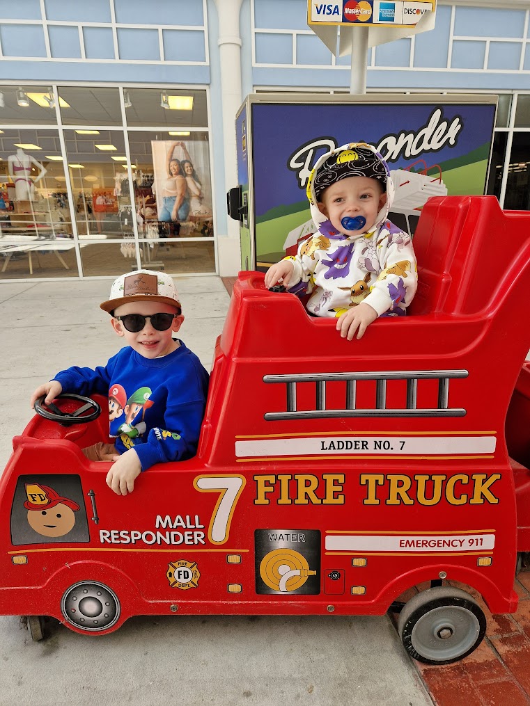 Children playing in the fire truck shopping cart at Tanger Outlets, North Charleston.